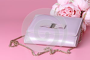 Female lady clatch bag on pink background