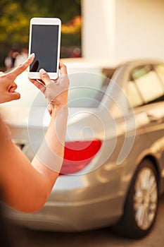 Female Lady using app on smart phone device, technology concept. Lady hand using remote control to send signal to unlock car doors