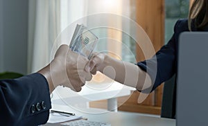 A female lawyer or business legal consultant receives a bribe or tribute from her client in the office. Corruption