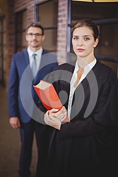 Female lawyer with businessman standing in background