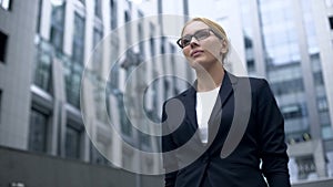 Female lawyer confidently walking out of court, gender and racial equality