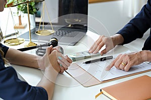 Female lawyer having a meeting with her client to sign the agreement contract