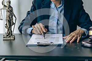 Female lawyer office working with hammer and scales with document,