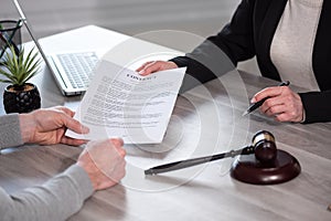 Female lawyer showing a document to her client