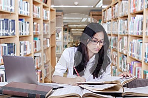 Female learner doing assignment in library