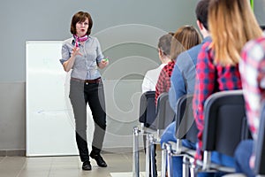 Female Lecturer delivering Presentation to Audience