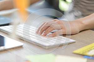 Female left-hand typing on bluetooth keyboard