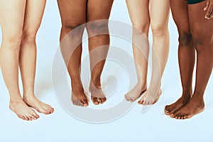 Female Leggs of different ethnicity and size over white background, close up