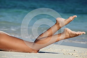 Female legs on beach