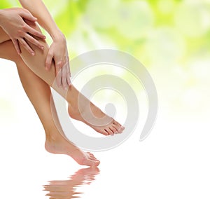 Female legs being massaged on water