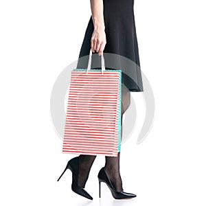 Female legs in black high heels shoes bags package black skirt fashion goes