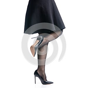 Female legs in black high heels shoes black skirt fashion