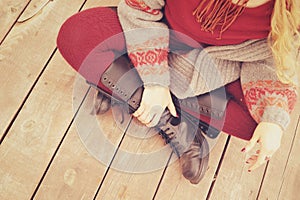 Female legs dressed in leather shoes with laces and knitted stockings photo