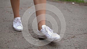 Female legs going on street