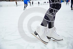 Female legs in ice skates photo