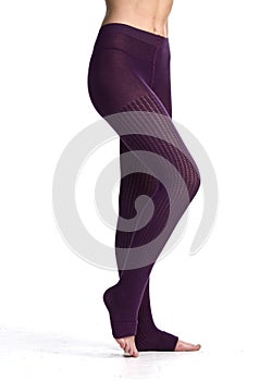 female legs in leggins purple in front of white background