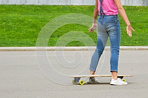 Female legs with a longboard closeup.Girl is preparing to ride on the board. For Copy Space.