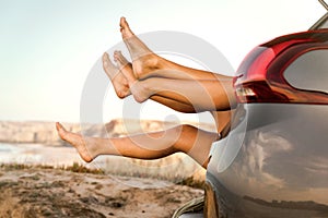 Female legs out of the car