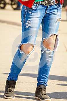 Female legs in ripped jeans