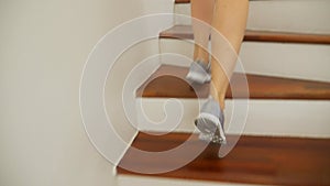 Female legs in sneakers running along a wooden ladder