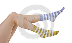 Female legs in socks of different colors