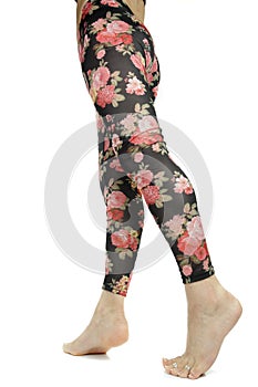 Female legs wearing floral leggings