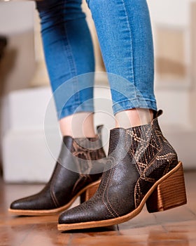 Female legs wearing leather fashion shoes of different casual and dress styles in assorted colors