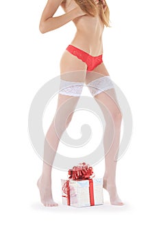 female legs in white stockings with gift