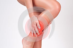 Female legs. Woman massaging her shin