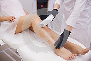 Female legs, woman in professional beauty clinic during laser hair removal