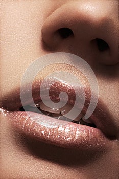 female lips with beige shiny gloss make-up