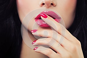 Female Lips and Nails Closeup. Pink Nail Polish