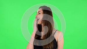 Female listens attentively and nods his head showing finger gesture No, then smiling. Green screen