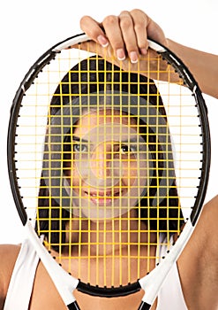 Female looking through strings of tennis racket
