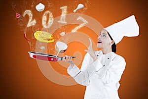 Female magician chef with numbers 2017