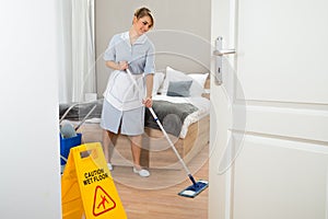 Female maid cleaning floor