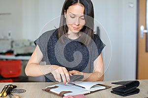 Female making belt to order.