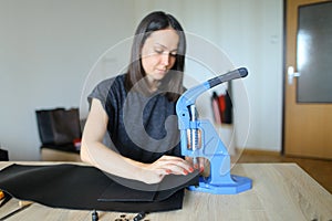 Female making belt to order.