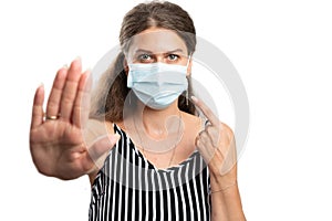 Female making stop stay away gesture pointing at medical mask