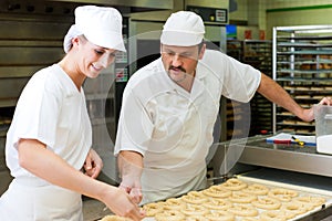 Female and male baker in bakery