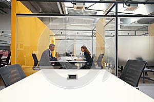 Female and male discussing work in the business center