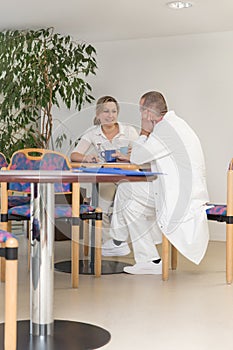 Female and male doctor in the breakroom of an hospital photo