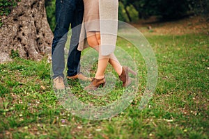 Female and male feet on grass