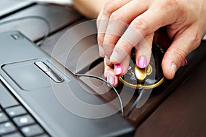 Female and male hands on mouse of notebook