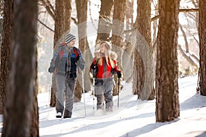 Female and male hiker walking in forest