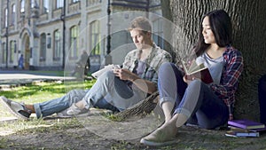 Female and male looking at each other, smiling, guy touches girl, affection