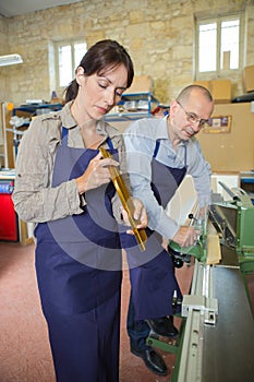 Female and male in metalworks workshop photo