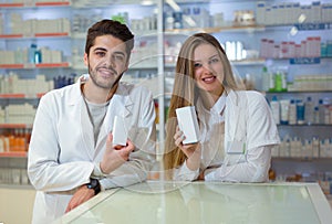 Female and male pharmacists in pharmacy