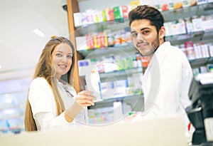 Female and male pharmacists in pharmacy