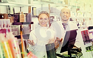 Female and male pharmacists working the pharmaceutical store